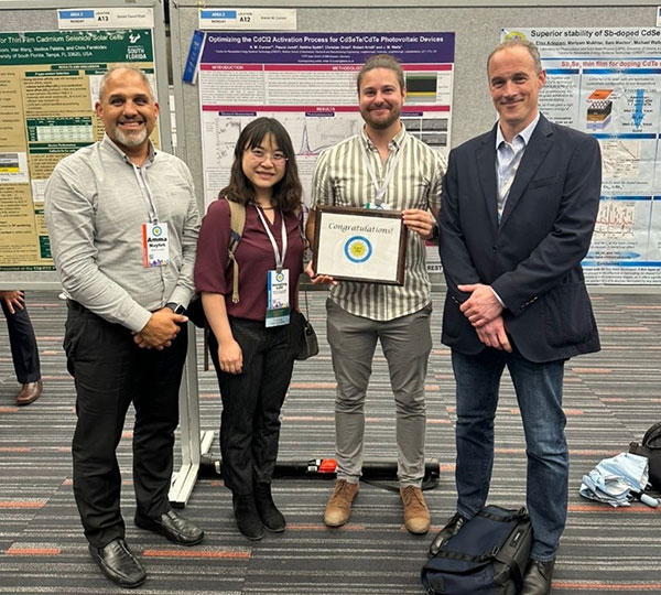 Kieran Curson holding his plaque for the best poster award at the 53rd IEEE PVSC