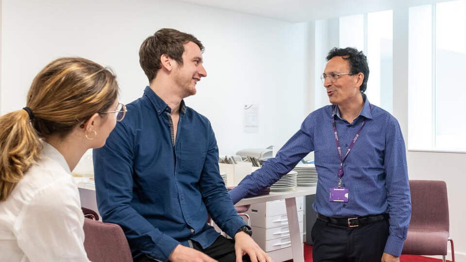 Staff member talking to students