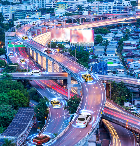 Smart cars with automatic sensors and wireless connection, driving through a city at night