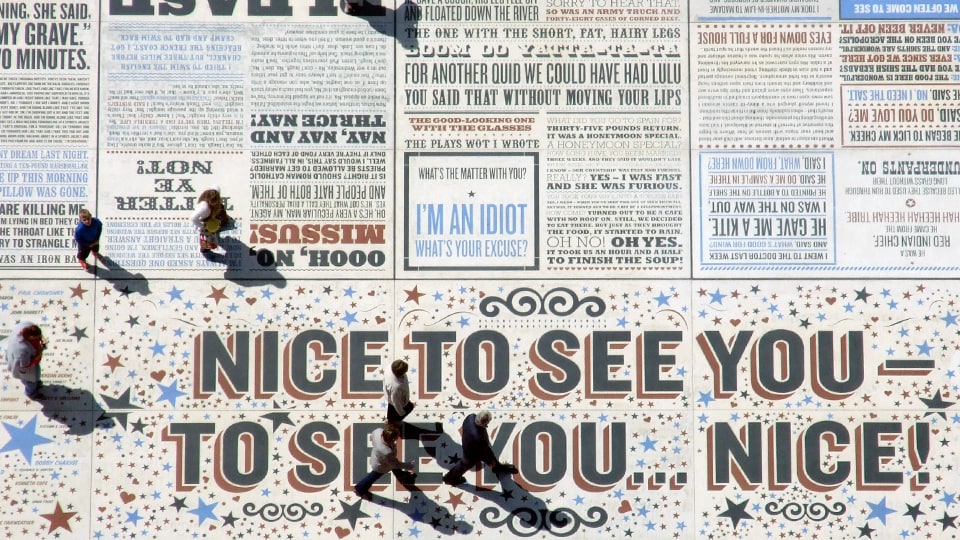 People walking on urban floor art