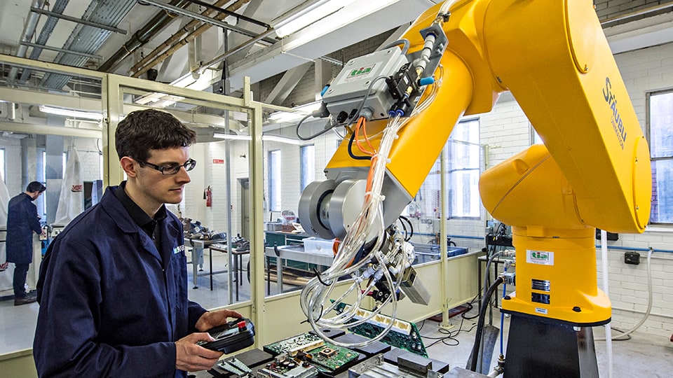 Person controlling manufacturing robotics