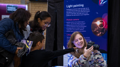 Scientist shows a family group their infrared photograph