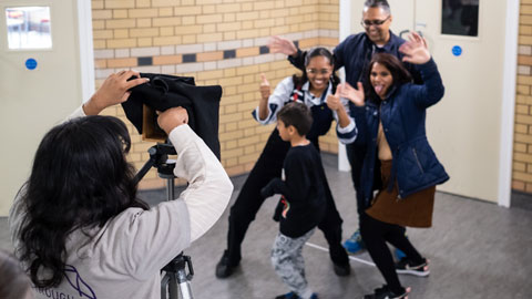 A group of people posing as one of the researchers takes a photo of them using a pinhole camera - there's a lot of face pulling!