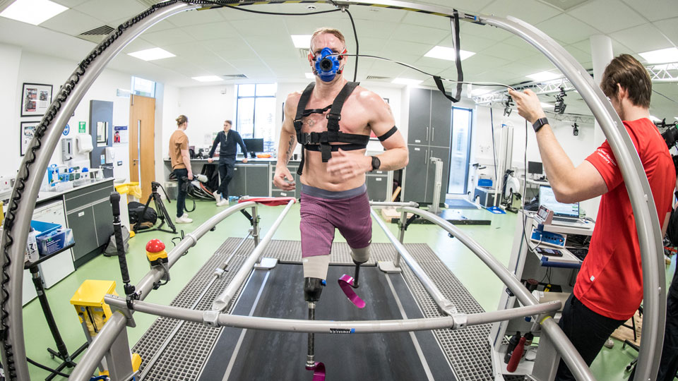 Para athlete on a treadmill, running toward the camera