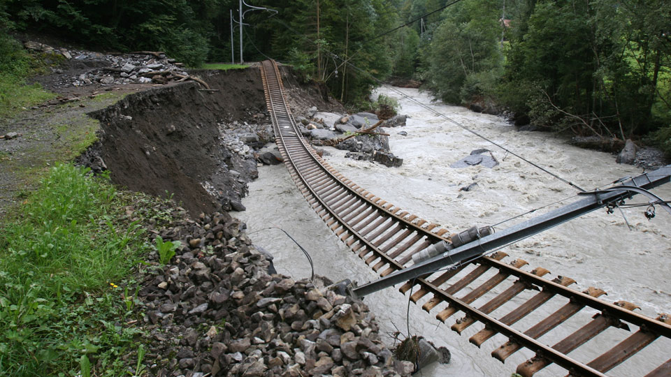 A railway line collapsed over a river, following a landslide