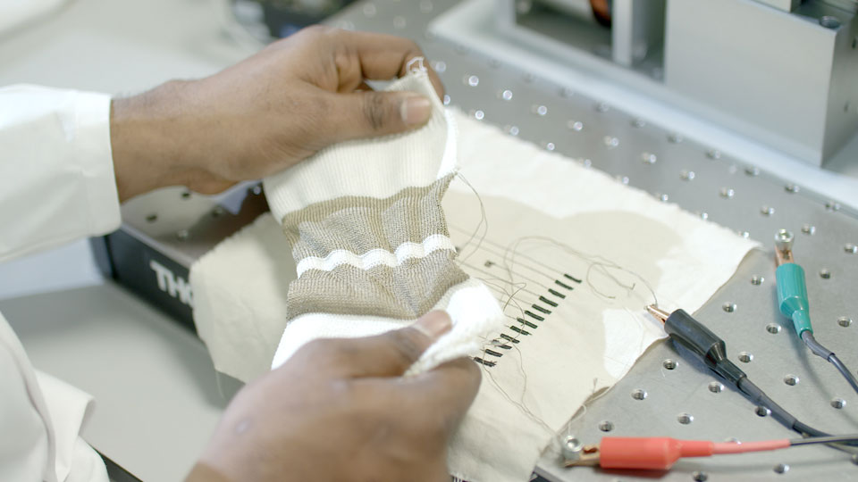 Close up shot of a researcher in a lab working on the smart textile