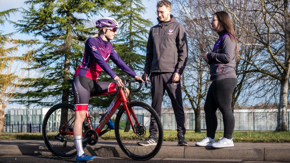 Two pedestrians chatting to a cyclist