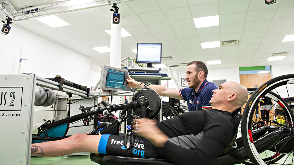 PHC researcher working with a hand-cyclist