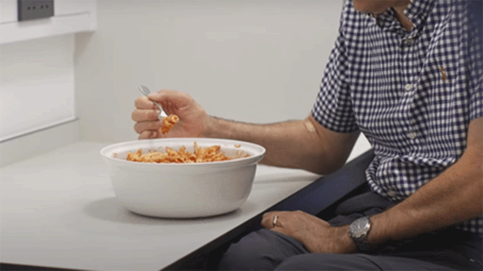 Male with tetraplegia enjoying a bowl of pasta