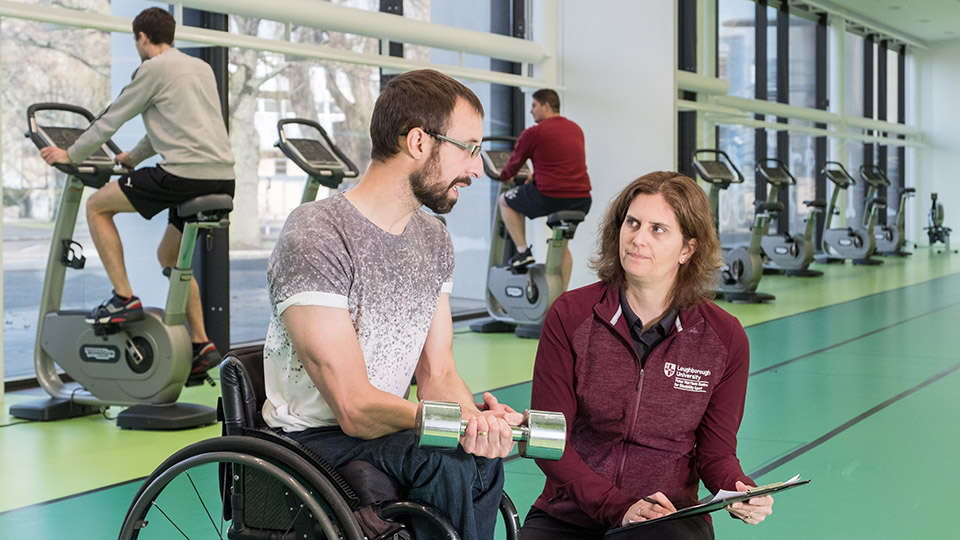 Prof Vicky Tolfrey talking to someone with a SCI in the National Centre for Sport and Exercise Medicine