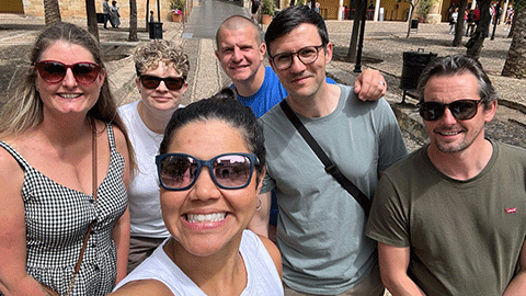 3 female and 3 male researchers taking a selfie in the sun