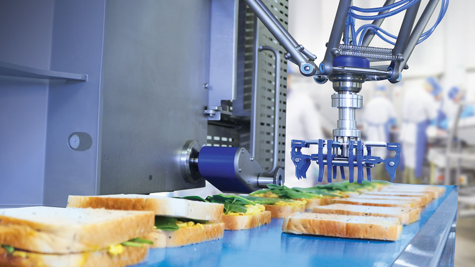 Close-up shot of the i-Gene delta robot in action, building sandwiches