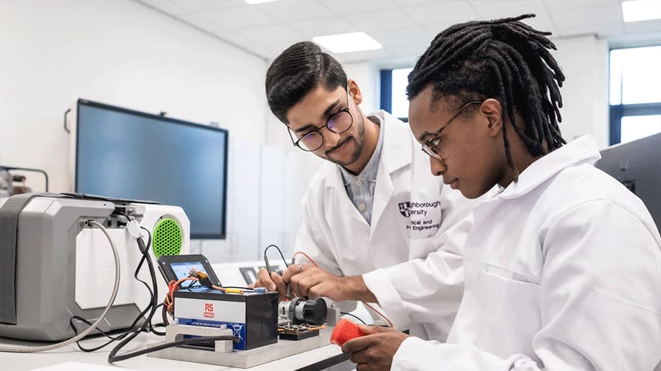 2 male students working in lab wearing lab coats