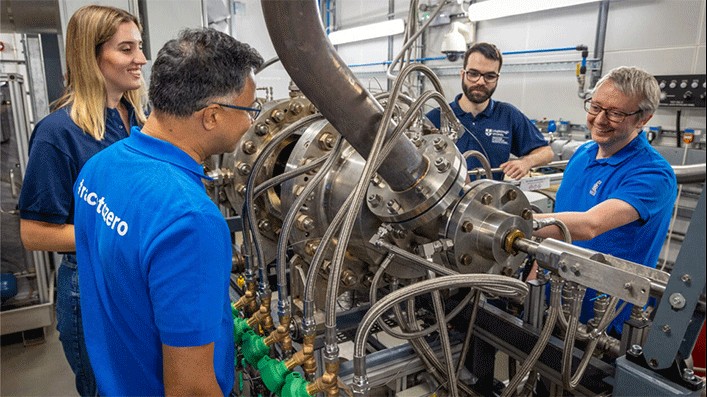 Researchers from NCCAT surrounding an engine