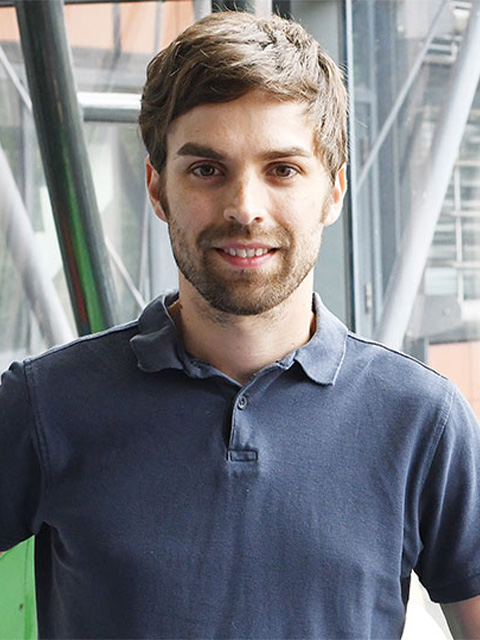 Headshot of Ashley in blue polo shirt
