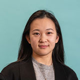 Headshot of Chengyuan with blue background