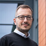 Headshot of Georgios stood outside Stewart Miller building