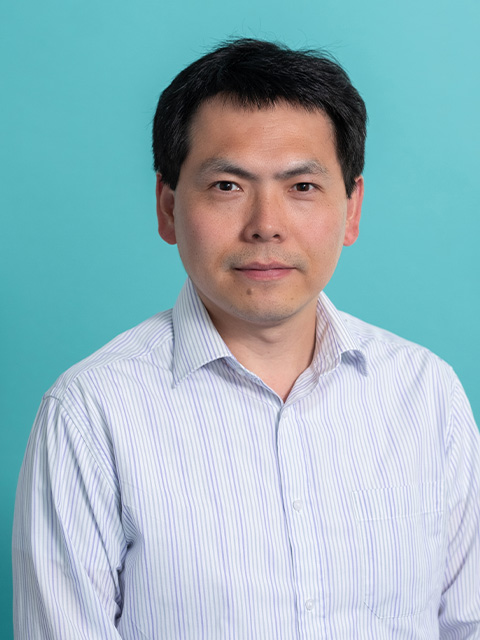 Headshot of Hao in striped shirt