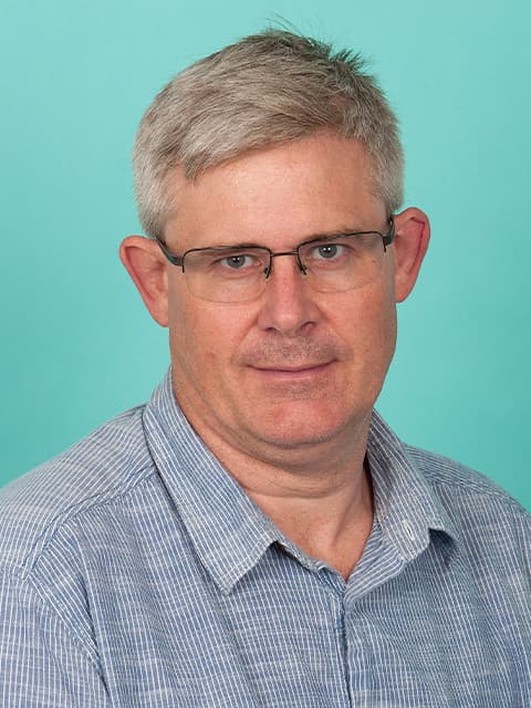 headshot of man in glasses