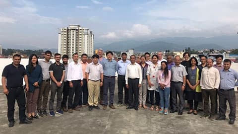 a group of people stand for a photo