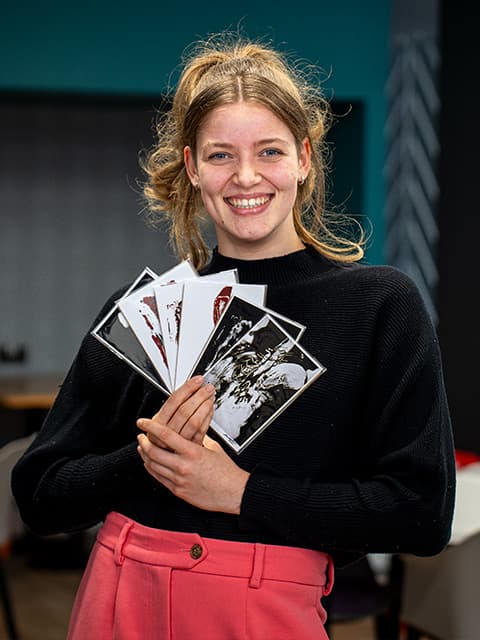 Becky Sweet holding her work
