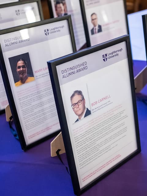 A set of framed award certificates.