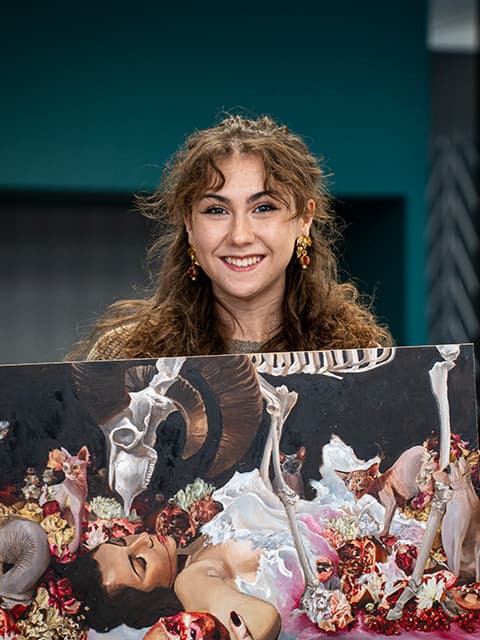 Holly Nixon holding her artwork