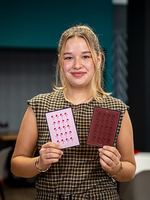 Izzy Tall holding her artwork