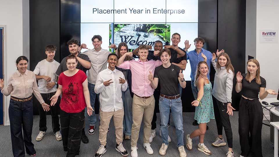 The 'Year in Enterprise' 2023/24 cohort of students stood facing the camera in various poses