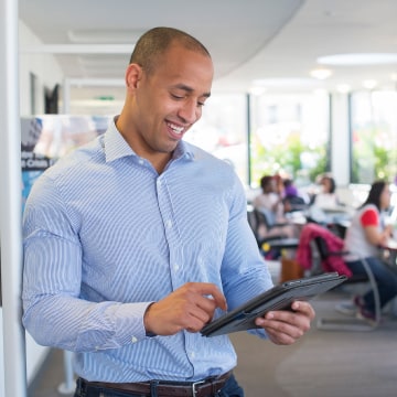 A man in an office using a tablet