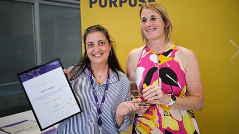 Suzanne Elayan receiving an award on behalf of Peter Kawalek from the Dean.