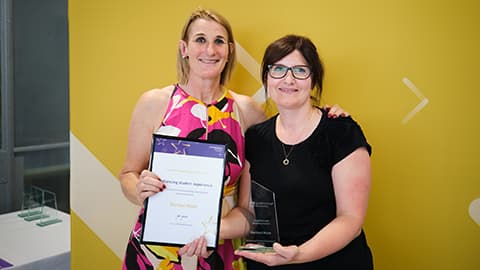 Rachael Mabe receiving an award from the Dean.