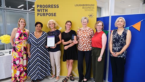 Loughborough Business School Ofsted team receiving an award from the Dean.