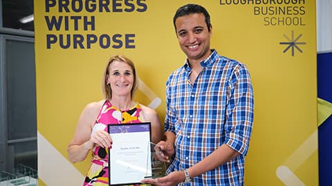 Yasser Eliwa receiving an award from the Dean.