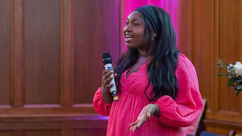 A student delivering a talk at an event.