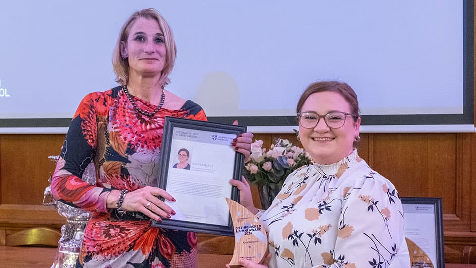 Katy Samuels receiving an award from Jan Godsell.