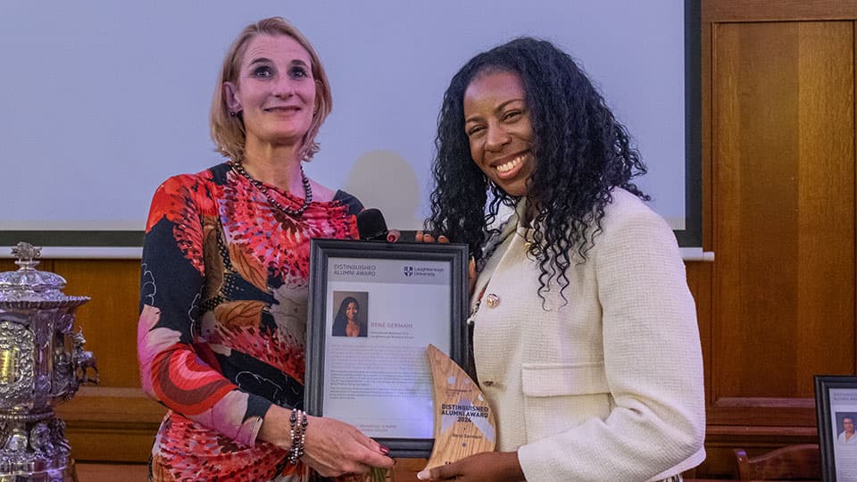 Renè Germain receiving an award from Jan Godsell.