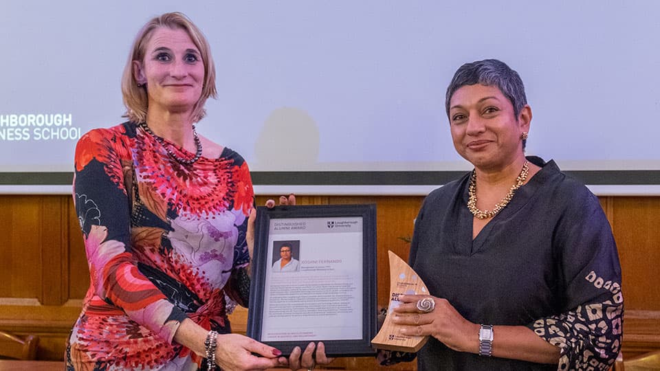 Roshni Fernando receiving an award from Jan Godsell.