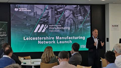A person delivering a presentation. The screen behind them reads 'Leicestershire Manufacturing Network Launch'.