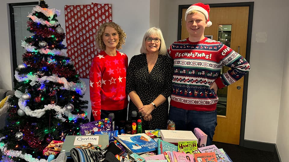 Kate Broadhurst, Vicki Unwin and Tomasz Cendrowski with items collected for the Christmas appeal.