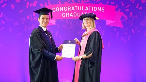 Hristian Momchilov Mladenov on stage with their certificate from Professor Jan Godsell.