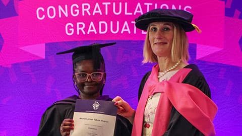 Muriel Larieux Tokam Maptue on stage with their certificate from Professor Jan Godsell.