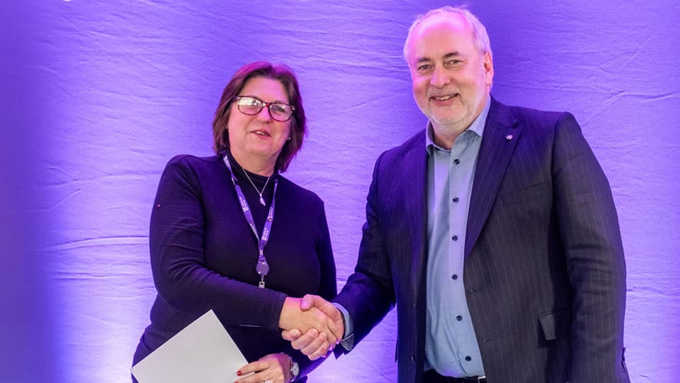 Diane Butlin shaking hands with Nick Jennings.