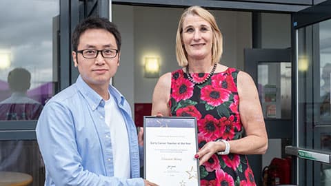Chaowei Wang receiving an award from Jan Godsell.