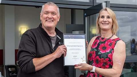 Steve Caron receiving an award from Jan Godsell.