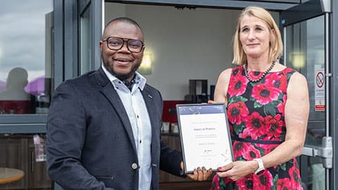 Albert Attom receiving an award from Jan Godsell.