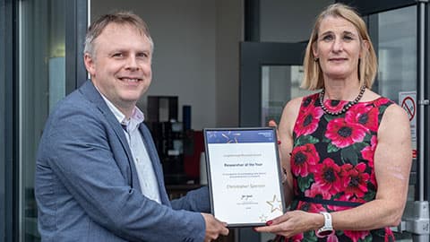 Christopher Spencer receiving an award from Jan Godsell.