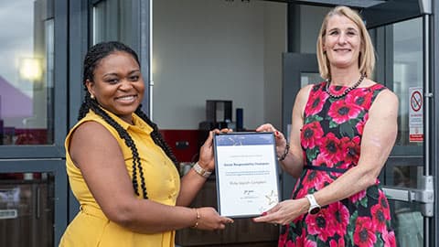 Ruby Appiah-Campbell receiving an award from Jan Godsell.