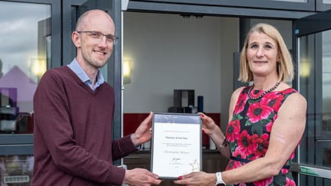 Chris Wilson receiving an award from Jan Godsell.