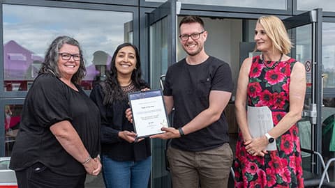 Colleagues from the Business School postgraduate team receiving an award from Jan Godsell.